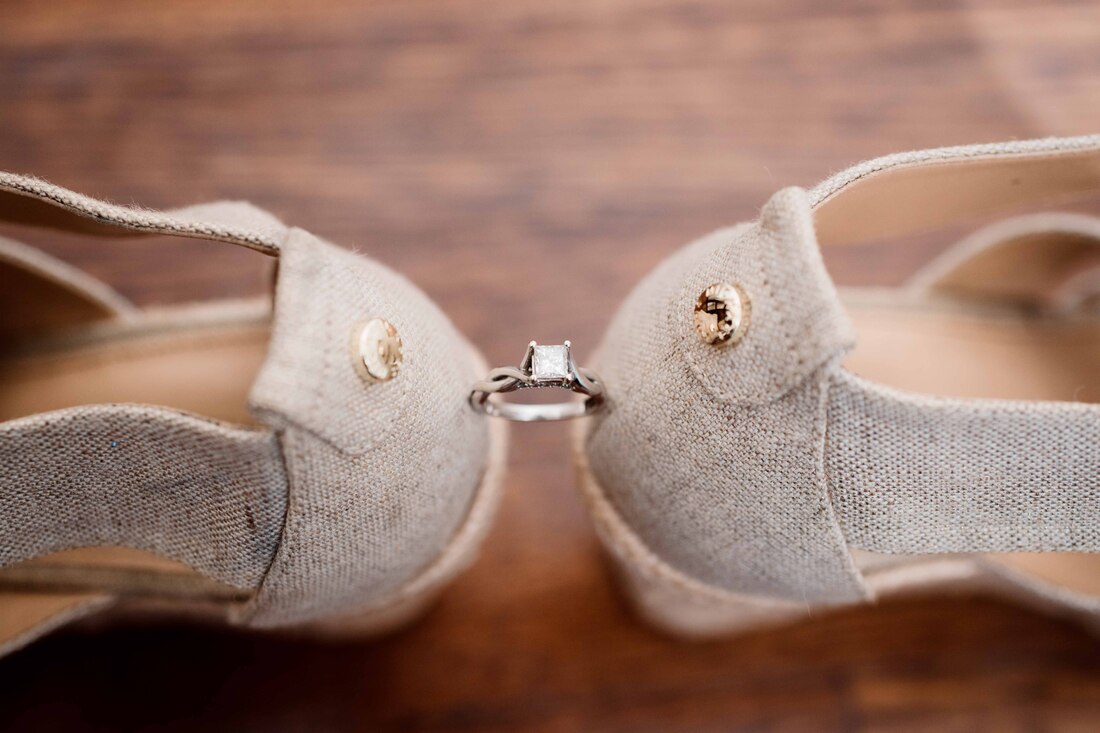 Close up of wedding ring in bride shoes